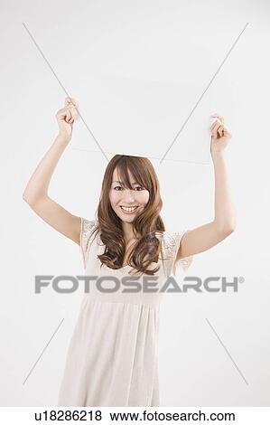 Stock Photo - Young woman holding up message board. Fotosearch