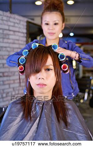 Hairdresser curling customer's hair, Hair Salon View Large Photo Image Stock Photo - Hairdresser curling customer's hair, Hair Salon. Fotosearch