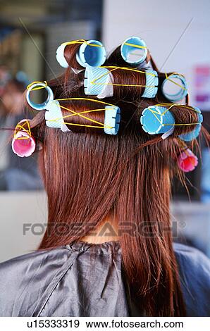 Stock Photo - Young girl having her hair curled, Hair Salon. Fotosearch