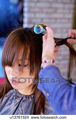 Young woman having her hair curled, Hair Salon View Large Photo Image Picture - Young woman having her hair curled, Hair Salon. Fotosearch