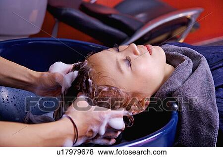 Stock Photo - Young woman having her hair washed, Hair Salon. Fotosearch