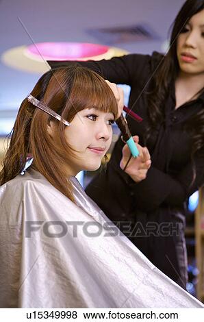 Hairdresser curling customer's hair, Hair Salon View Large Photo Image Stock Photo - Hairdresser curling customer's hair, Hair Salon. Fotosearch