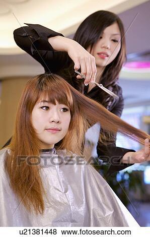 Stock Photo - Hairdresser cutting customer's hair, Hair Salon. Fotosearch