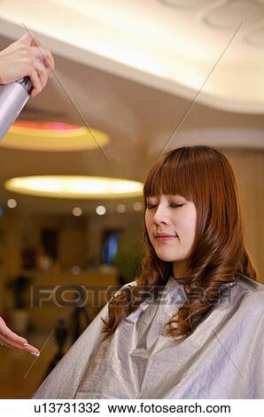Hairdresser using hairspray on customer's hair, Hair Salon View Large Photo Image Stock Image - Hairdresser using hairspray on customer's hair, Hair Salon. Fotosearch