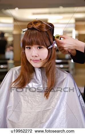 Young woman having her hair curled, Hair Salon View Large Photo Image Stock Image - Young woman having her hair curled, Hair Salon. Fotosearch