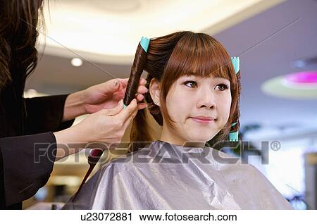 Young woman having her hair curled, Hair Salon View Large Photo Image Stock Image - Young woman having her hair curled, Hair Salon. Fotosearch