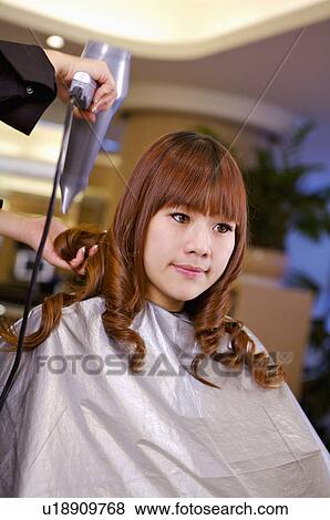 Young woman having her hair dried, Hair Salon View Large Photo Image Stock Photo - Young woman having her hair dried, Hair Salon. Fotosearch