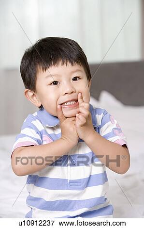 Stock Photo - A boy making a face lovely. Fotosearch