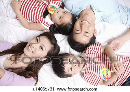 Family, Family lying on bed View Large Photo Image Stock Image - Family, Family lying on bed. Fotosearch
