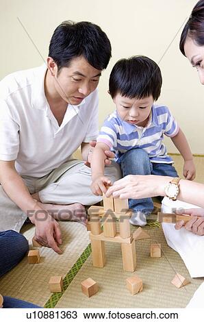 Family, family playing block game together View Large Photo Image Stock Image - Family, family playing block game together. Fotosearch
