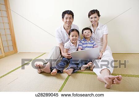 Family, family using a laptop on the floor View Large Photo Image Stock Photography - Family, family using a laptop on the floor. Fotosearch