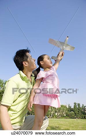 Family, father and daughter playing toy airplane outdoors View Large Photo Image Stock Photo - Family, father and daughter playing toy airplane outdoors. Fotosearch