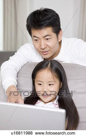 Stock Photo - Family, father and daughter using laptop. Fotosearch