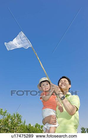 Stock Photo - Family, Father and son catching bugs. Fotosearch
