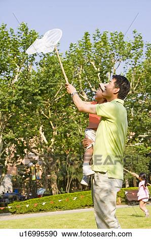 Family, father catching bugs with his son View Large Photo Image Stock Image - Family, father catching bugs with his son. Fotosearch
