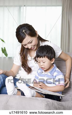 Stock Image - Family, mother and son reading together. Fotosearch