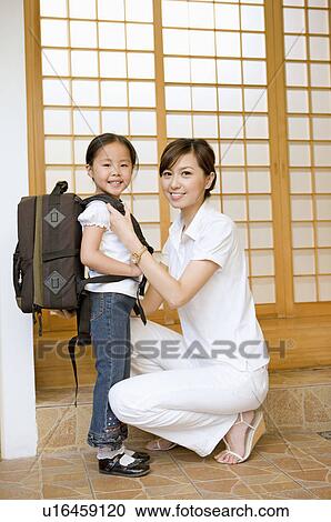 Family, Mother help her daughter dressed up for school View Large Photo Image Stock Image - Family, Mother help her daughter dressed up for school. Fotosearch