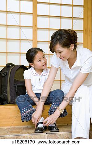 Family, mother helping daughter dressed up for school View Large Photo Image Stock Image - Family, mother helping daughter dressed up for school. Fotosearch