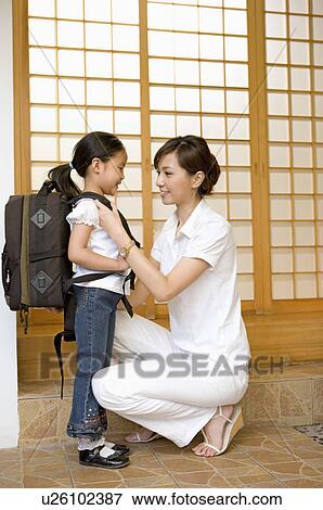 Family, Mother helping her daughter dressed up for school View Large Photo Image Stock Photo - Family, Mother helping her daughter dressed up for school. Fotosearch