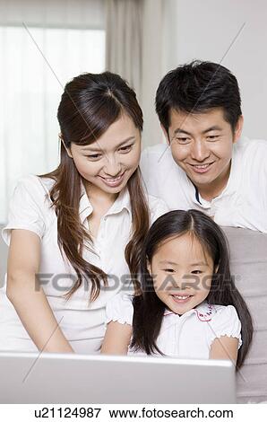 Stock Photo - Family, parents and daughter using laptop. Fotosearch