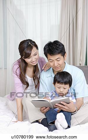 Family, parents helping their son writing View Large Photo Image Stock Photo - Family, parents helping their son writing. Fotosearch