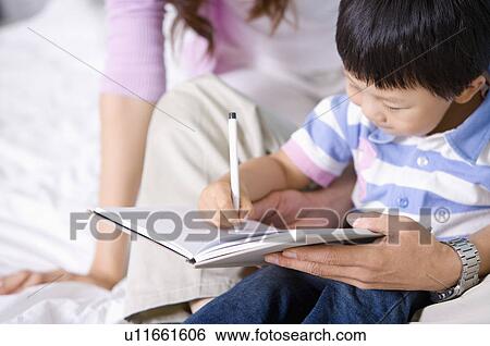 Family, parents helping their son writing View Large Photo Image Stock Photograph - Family, parents helping their son writing. Fotosearch
