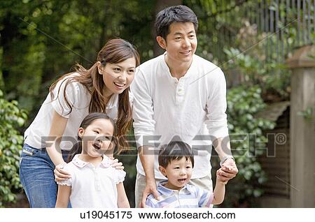 Stock Photography - Family, Portrait of a family, standing in front of a courtyard. Fotosearch