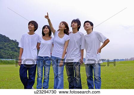 Five teenagers standing on the lawn and looking up together, Teenager View Large Photo Image Stock Image - Five teenagers standing on the lawn and looking up together, Teenager. Fotosearch