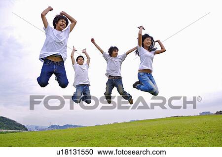 Four teenagers jumping on the lawn with arms outstretched, Teenager View Large Photo Image Stock Image - Four teenagers jumping on the lawn with arms outstretched, Teenager. Fotosearch