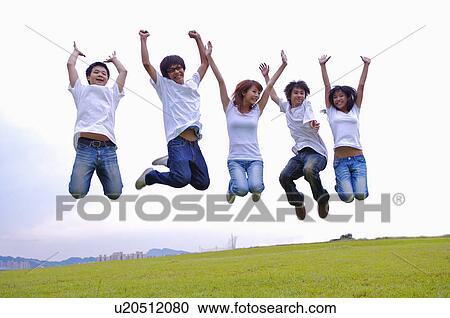 Teenagers jumping on the lawn with arms outstretched, Teenager View Large Photo Image Stock Image - Teenagers jumping on the lawn with arms outstretched, Teenager. Fotosearch
