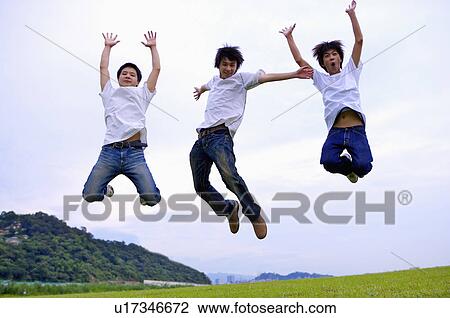 Three boys jumping high with arms outstretched, Teenager View Large Photo Image Stock Image - Three boys jumping high with arms outstretched, Teenager. Fotosearch