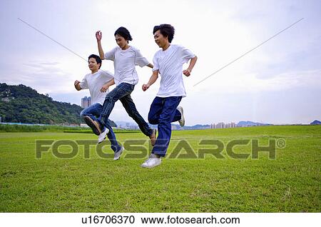 Three boys jumping on the lawn, Teenager View Large Photo Image Stock Image - Three boys jumping on the lawn, Teenager. Fotosearch