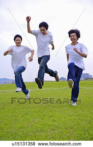 Three boys running and jumping on the lawn, Teenager View Large Photo Image Stock Photo - Three boys running and jumping on the lawn, Teenager. Fotosearch