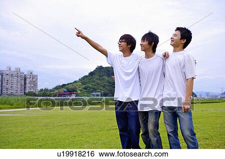 Three boys standing on the lawn and looking up together, Teenager View Large Photo Image Stock Photograph - Three boys standing on the lawn and looking up together, Teenager. Fotosearch