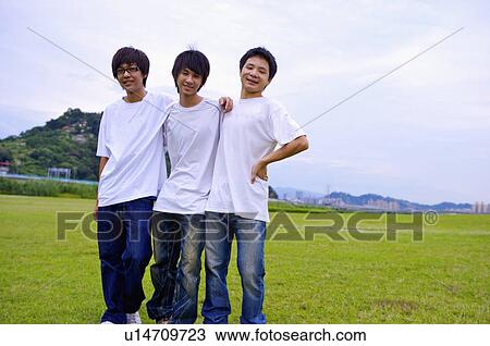 Three boys standing on the lawn with hands on shoulder, Teenager View Large Photo Image Stock Image - Three boys standing on the lawn with hands on shoulder, Teenager. Fotosearch