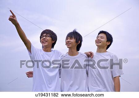Three boys standing together with hands on shoulder and looking up, Teenager View Large Photo Image Stock Image - Three boys standing together with hands on shoulder and looking up, Teenager. Fotosearch
