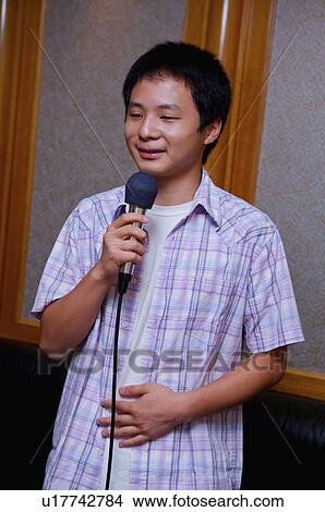 Teenager boy holding microphone and sing, Teenager View Large Photo Image Picture - Teenager boy holding microphone and sing, Teenager. Fotosearch