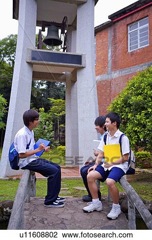 Teenager boy sitting on the baluster with books and discussing together, Teenager View Large Photo Image Stock Image - Teenager boy sitting on the baluster with books and discussing together, Teenager. Fotosearch