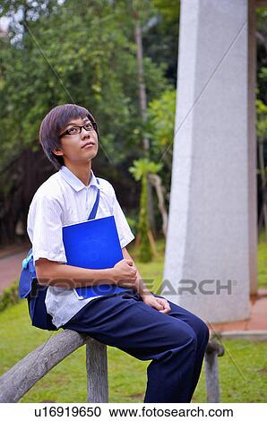 Teenager boy sitting on the baluster and looking up, Teenager View Large Photo Image Stock Image - Teenager boy sitting on the baluster and looking up, Teenager. Fotosearch