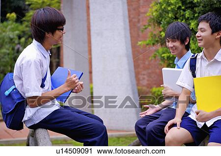 Teenager boys sitting, holding books and discussing, Teenager View Large Photo Image Stock Image - Teenager boys sitting, holding books and discussing, Teenager. Fotosearch