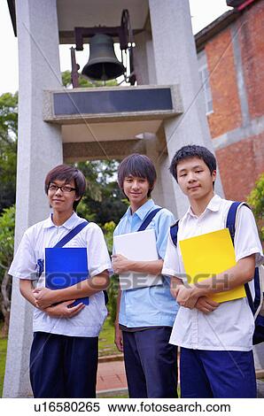 Teenager boys standing with books and looking away, Teenager View Large Photo Image Stock Photography - Teenager boys standing with books and looking away, Teenager. Fotosearch