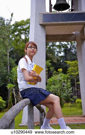 Teenager girl sitting on the baluster and looking up, Teenager View Large Photo Image Stock Photo - Teenager girl sitting on the baluster and looking up, Teenager. Fotosearch