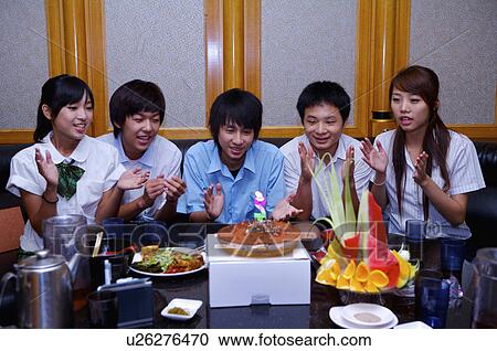 Stock Image - Teenagers celebrating and applauding together, Teenager. Fotosearch
