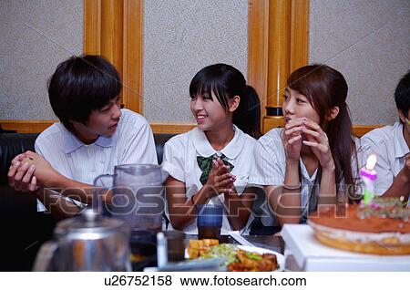 Stock Photo - Teenagers celebrating for birthday and discussing together, Teenager. Fotosearch