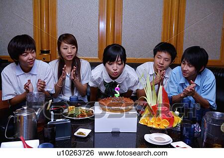 Stock Photograph - Teenagers celebrating for birthday and applauding, Teenager. Fotosearch