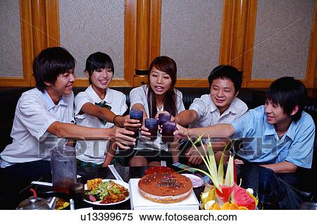 Stock Photography - Teenagers celebrating for birthday and toasting together, Teenager. Fotosearch