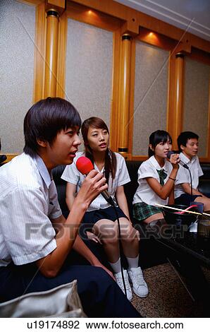 Teenagers sitting and singing together, Teenager View Large Photo Image Stock Image - Teenagers sitting and singing together, Teenager. Fotosearch