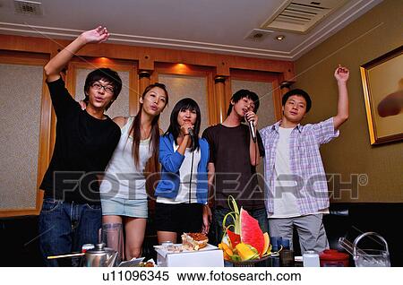 Teenagers standing and singing with hands on shoulder together, Teenager View Large Photo Image Stock Photography - Teenagers standing and singing with hands on shoulder together, Teenager. Fotosearch