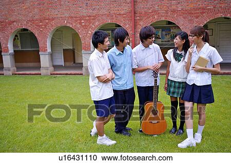 Teenagers standing on the lawn and smiling happily together, Teenager View Large Photo Image Stock Image - Teenagers standing on the lawn and smiling happily together, Teenager. Fotosearch