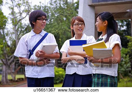 Teenagers standing with books and discussing together, Teenager View Large Photo Image Stock Photo - Teenagers standing with books and discussing together, Teenager. Fotosearch